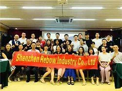 Rebow team group photo with a company banner, from the company profile